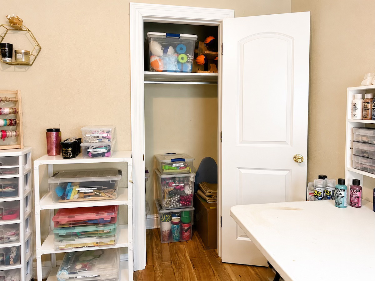 Organized craft room with labeled supplies, paints, and storage bins