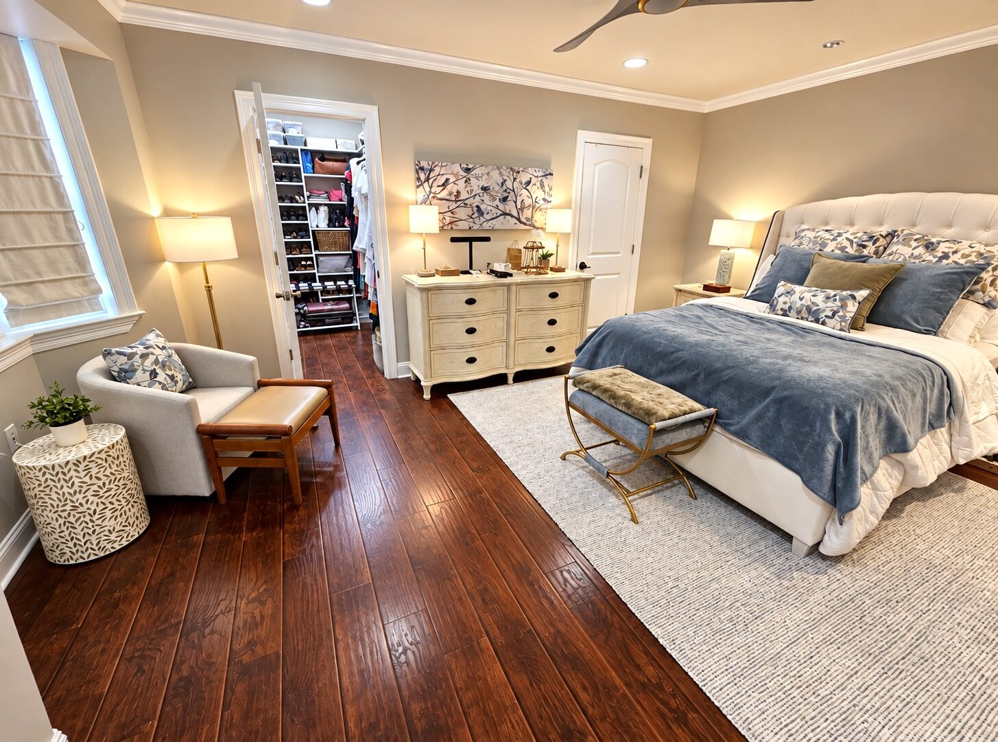 Metairie bedroom after closet organizing, with a clear bed, chair, and floor