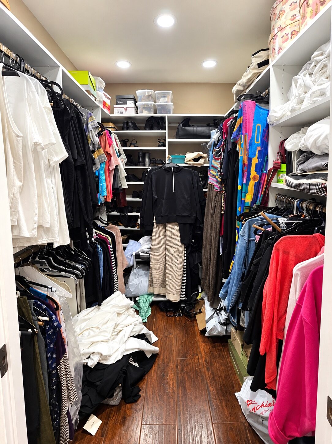 Metairie custom closet before decluttering, with clothes and belongings crowding the walkway