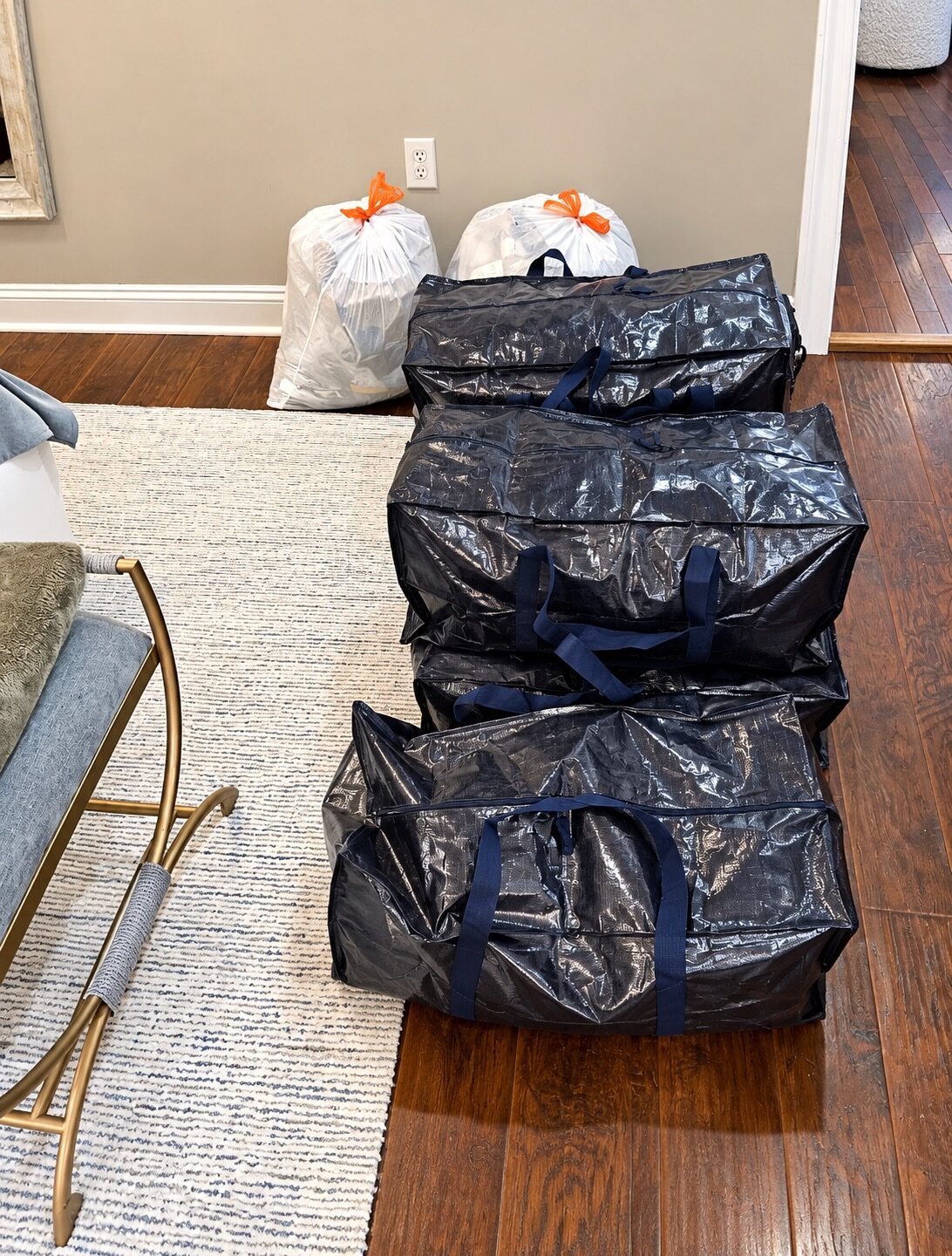 Bags and containers of items set aside while decluttering a Metairie closet