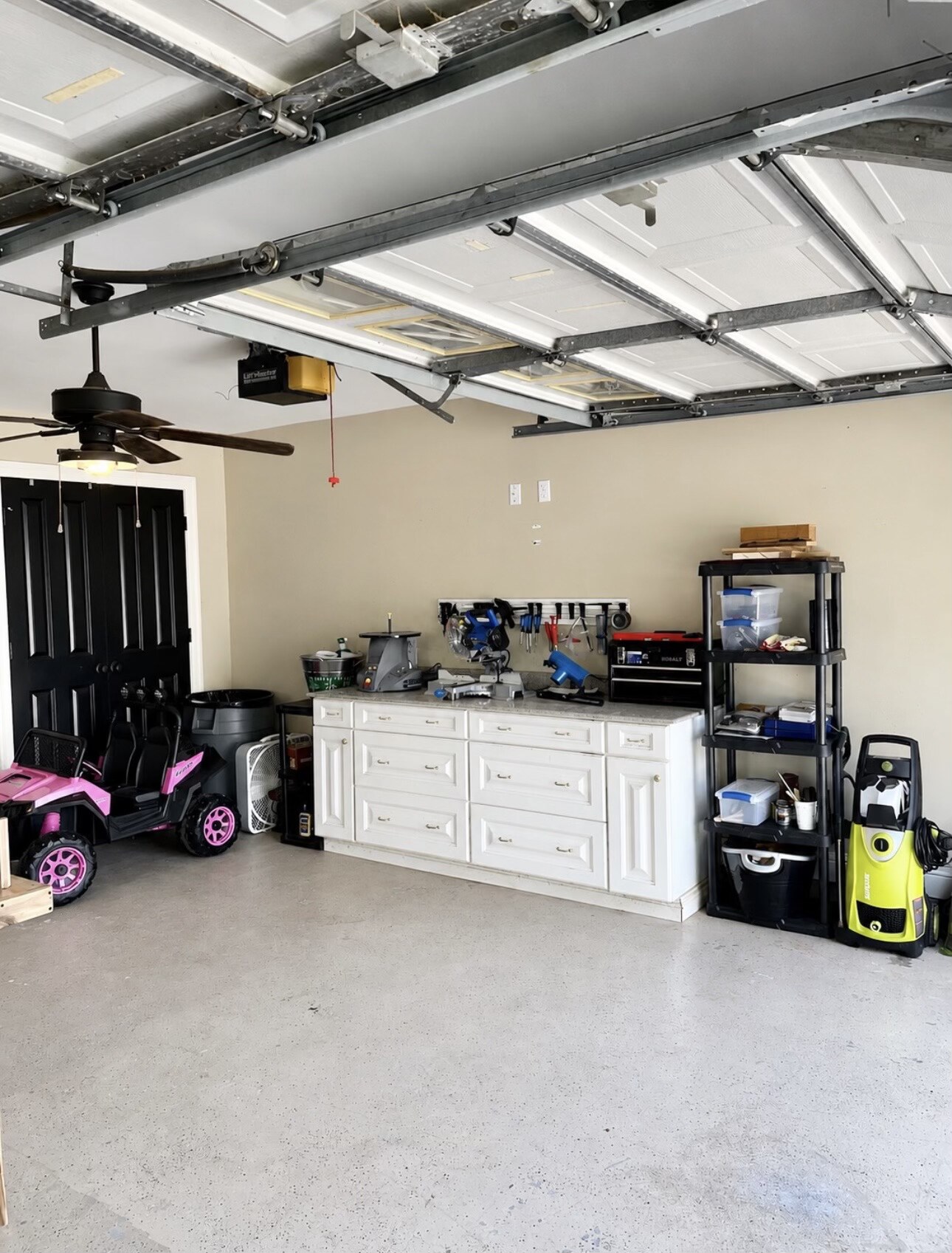 Organized garage workbench and storage after Nola Organizers completed the project