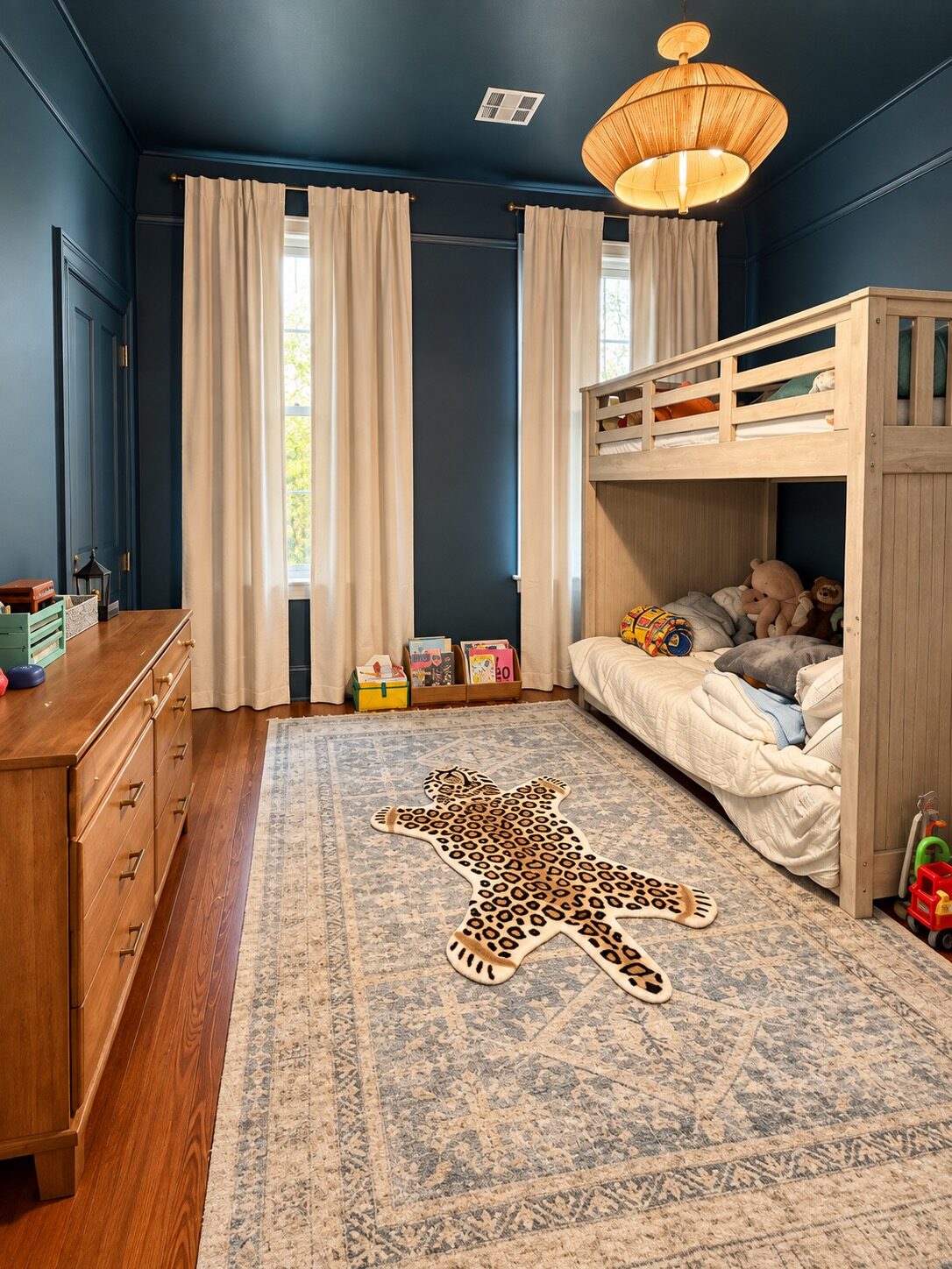 Navy bunk bedroom after unpacking, with an accessible dresser, books by the window, and a clear rug