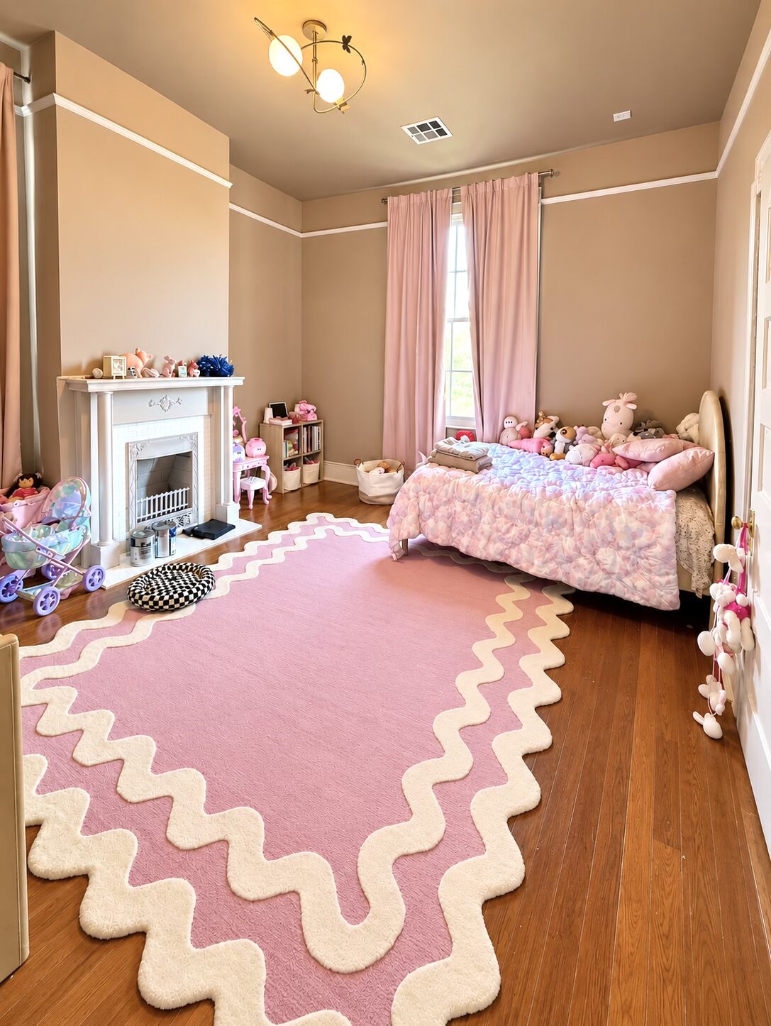 Pink children’s bedroom after organizing, with books on shelves, toys grouped in baskets, and open floor space