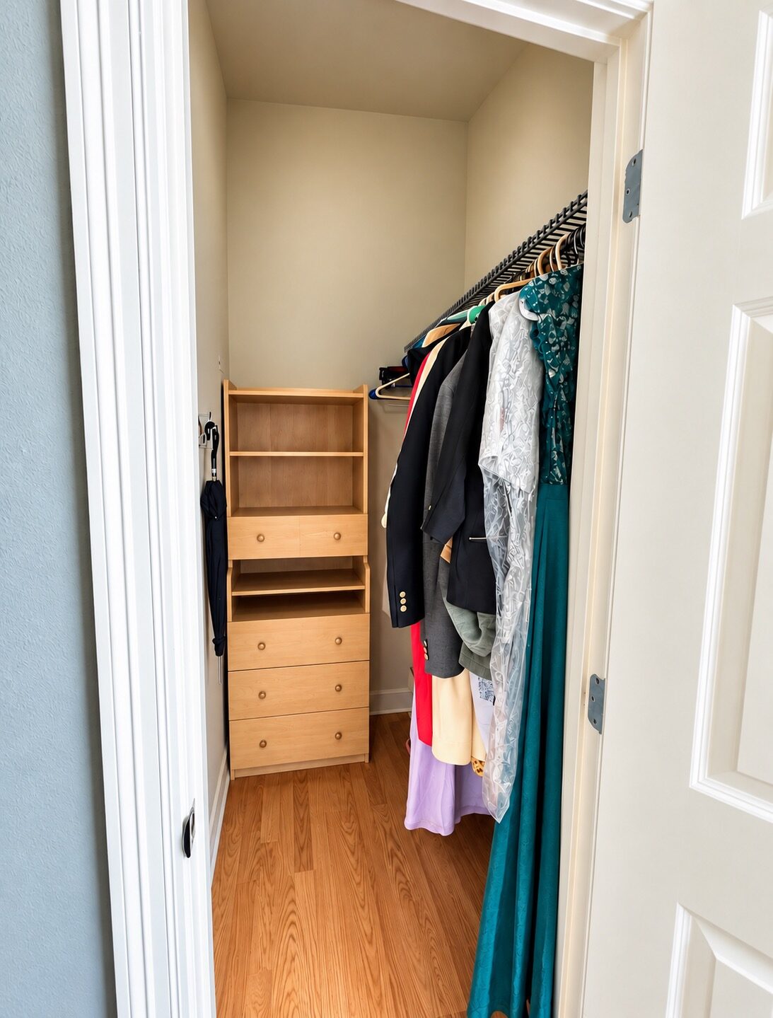 New Orleans closet after decluttering, with an open floor and accessible hanging clothes