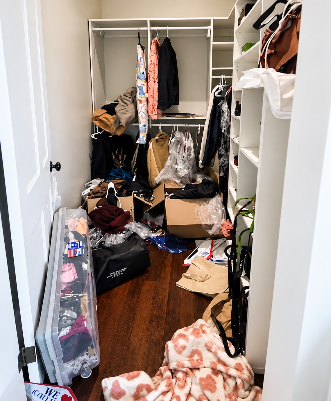 New Orleans closet with clothes, boxes, hangers, and packing materials before unpacking and organizing