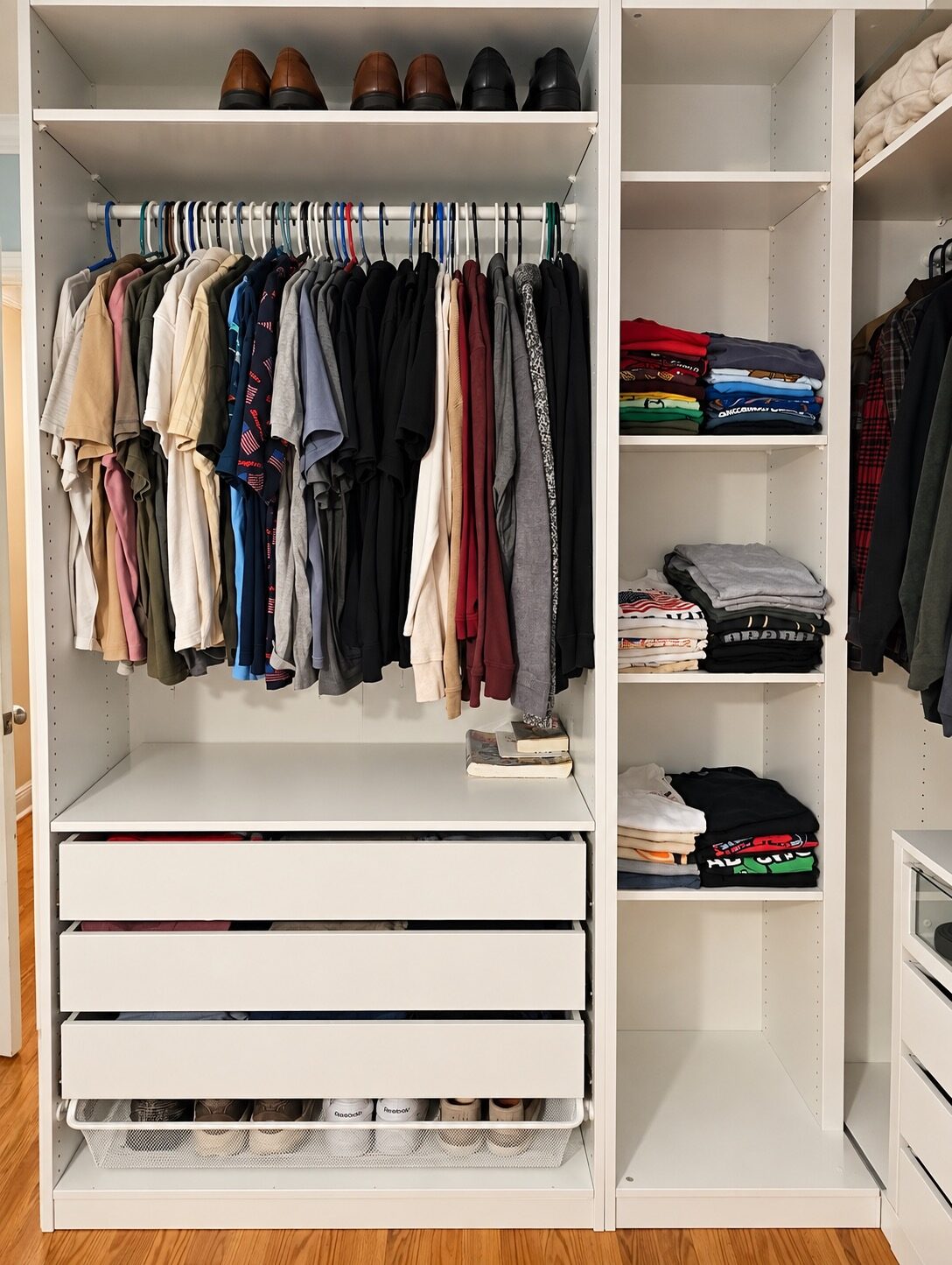 Hanging shirts and folded clothing arranged on shelves in the finished custom closet