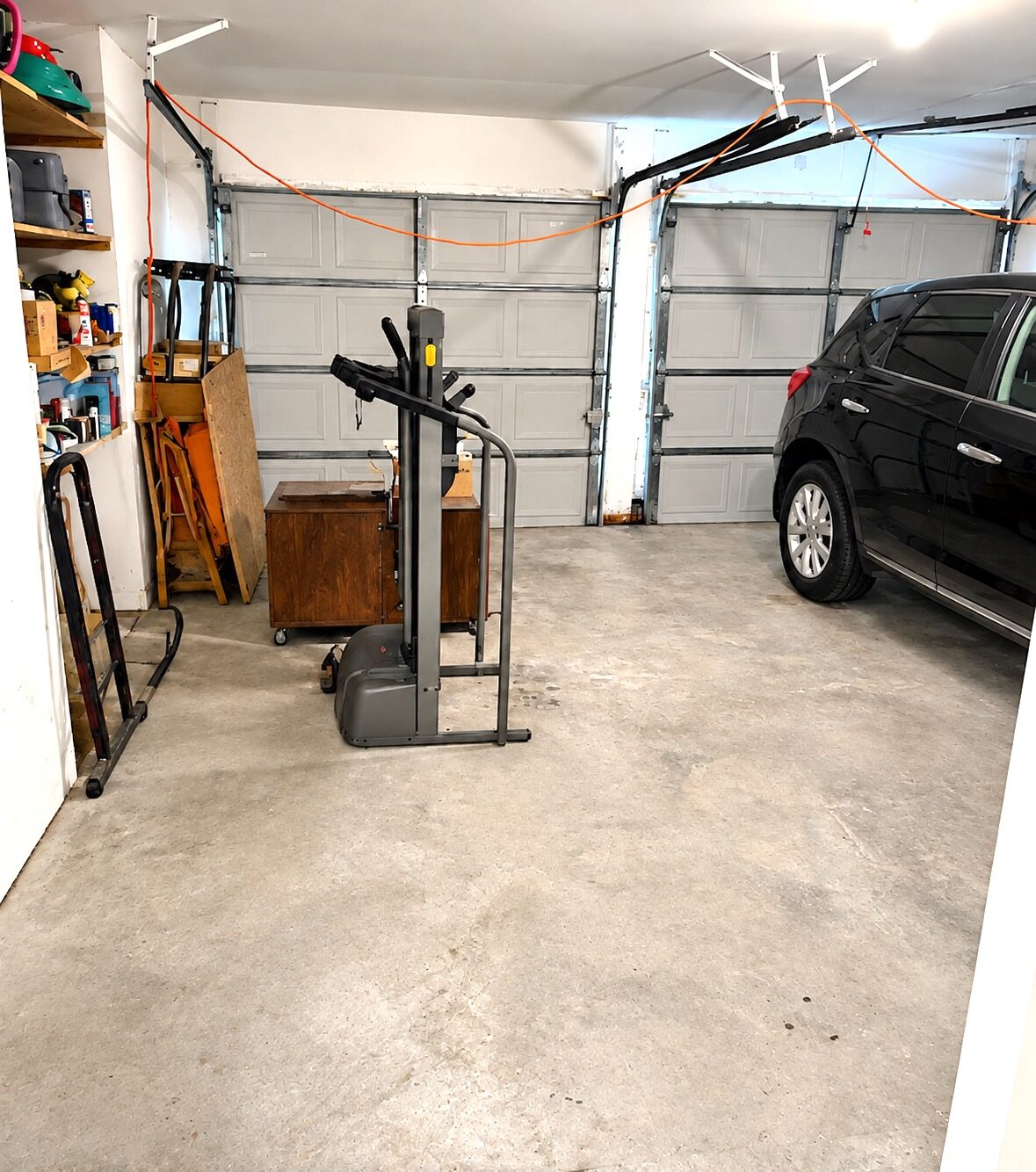 New Orleans garage after decluttering, with a cleared floor and organized belongings
