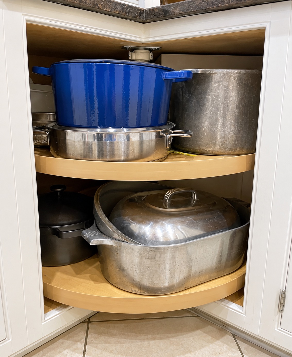 Pots and pans arranged in a lower kitchen cabinet