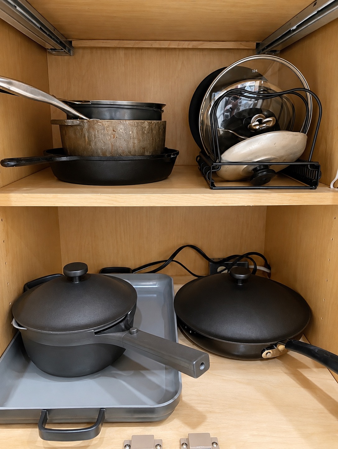 Additional pots and pans organized in a kitchen cabinet