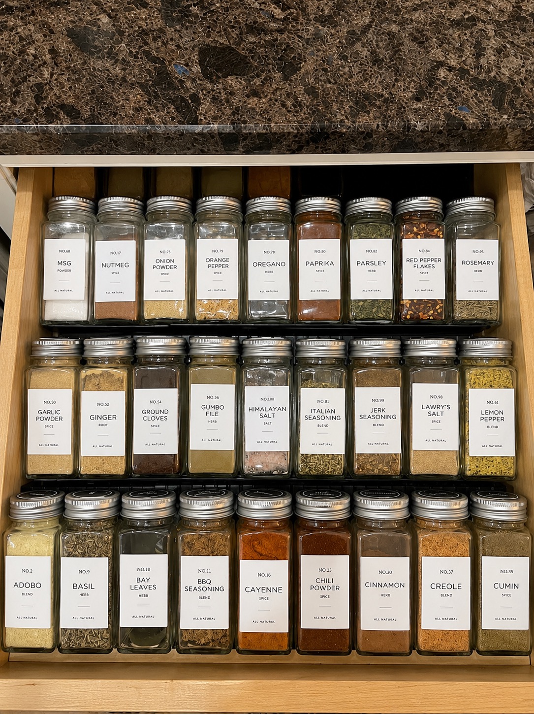 Spices arranged so labels are easier to see in a kitchen cabinet