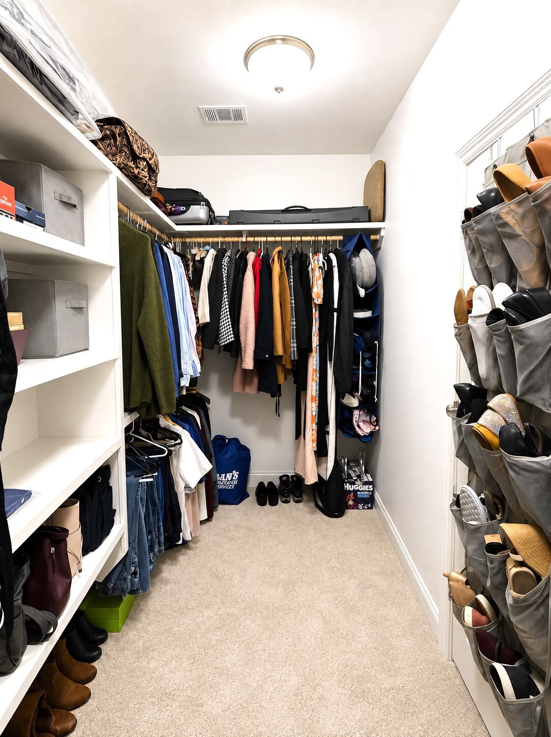 Finished walk-in closet in New Orleans with open floor space and organized shelves