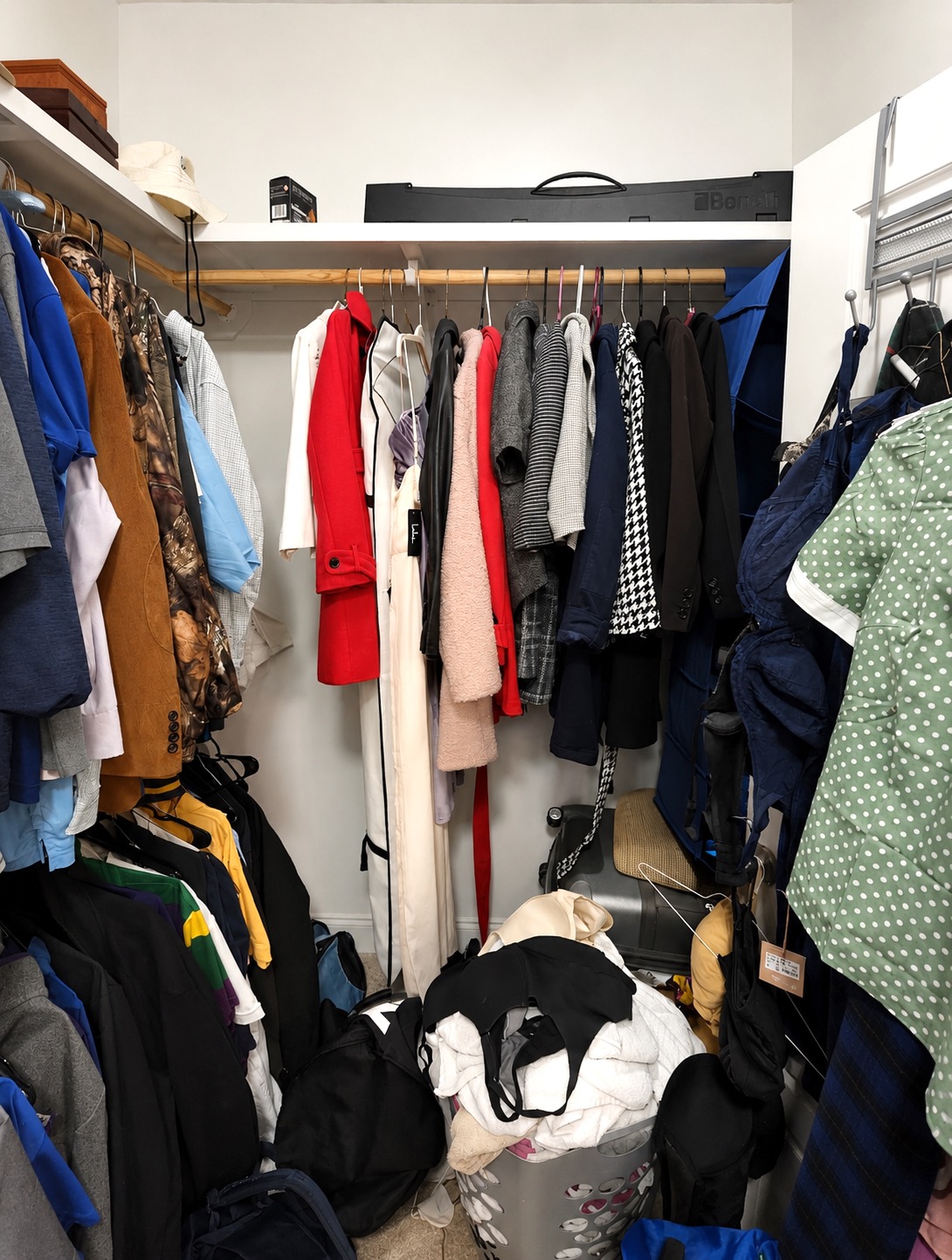 Another view of the walk-in closet before organizing in New Orleans