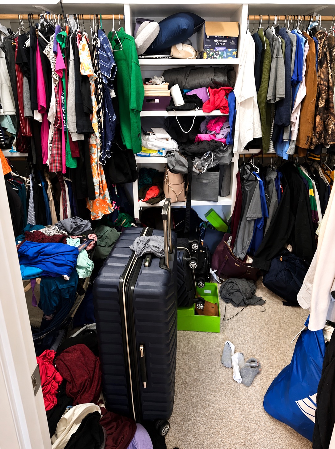 Walk-in closet in New Orleans before Nola Organizers decluttered and organized the space
