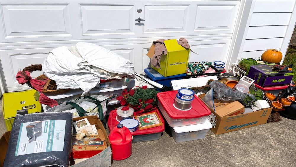 Large haul of donations and discarded items staged in a driveway after a decluttering session in Mandeville, LA