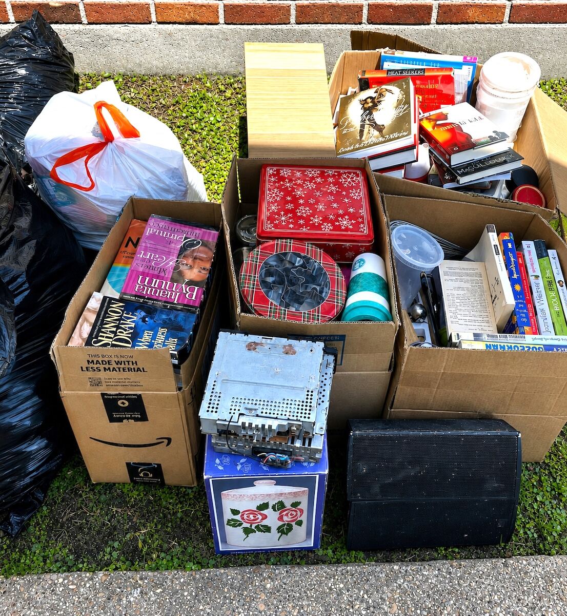 Boxes and items sorted and staged outside after a Nola Organizers decluttering session in New Orleans