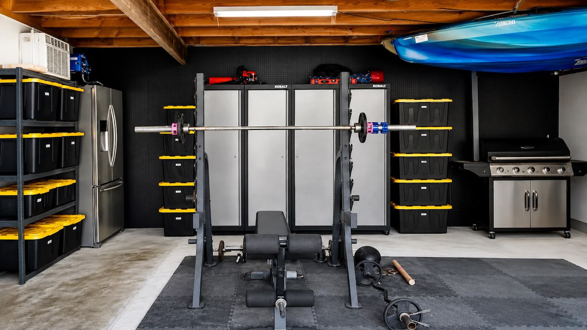 Organized garage with clear floor space and shelving by Nola Organizers New Orleans