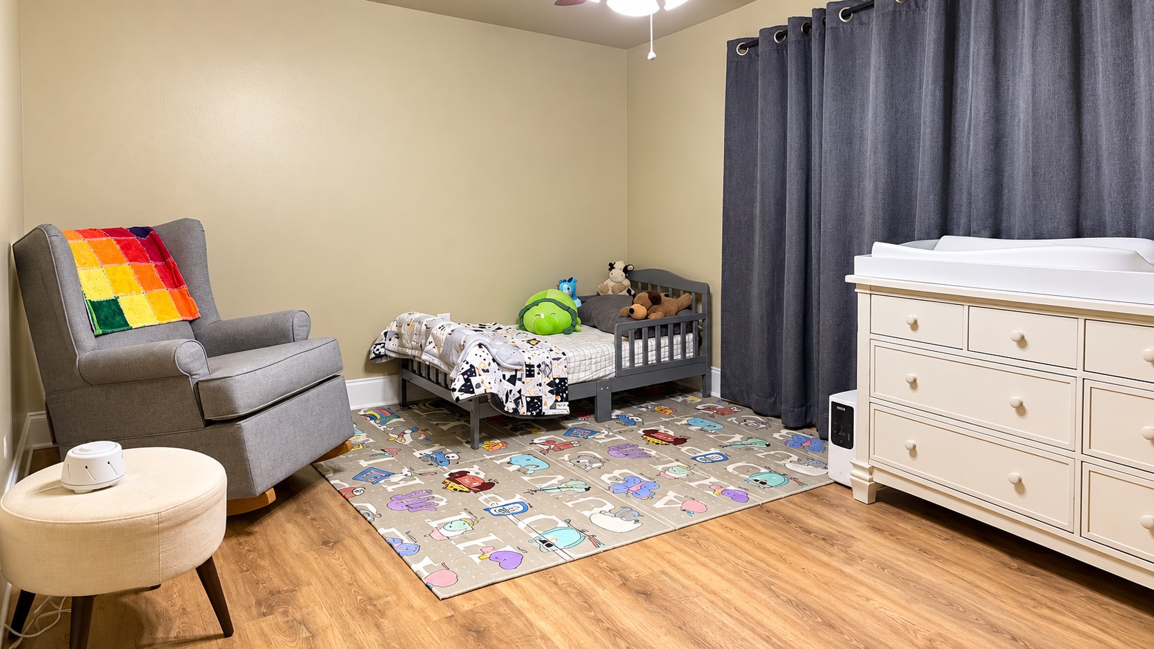 Child’s bedroom with a small bed, dresser, and reading chair